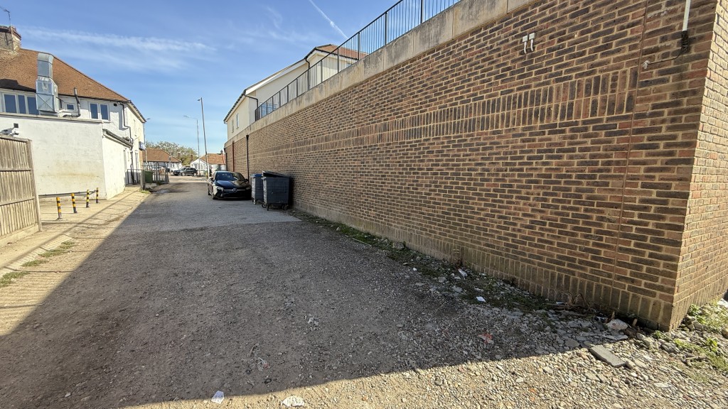 Lot: 150 - FREEHOLD PARCEL OF LAND INCLUDING PART OF THE ADJOINING ROADWAY - External view from rear of site